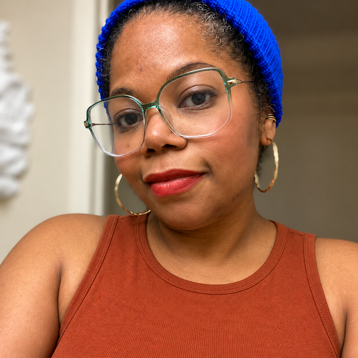 Nadege D. Okotie, artist and educator, wearing glasses